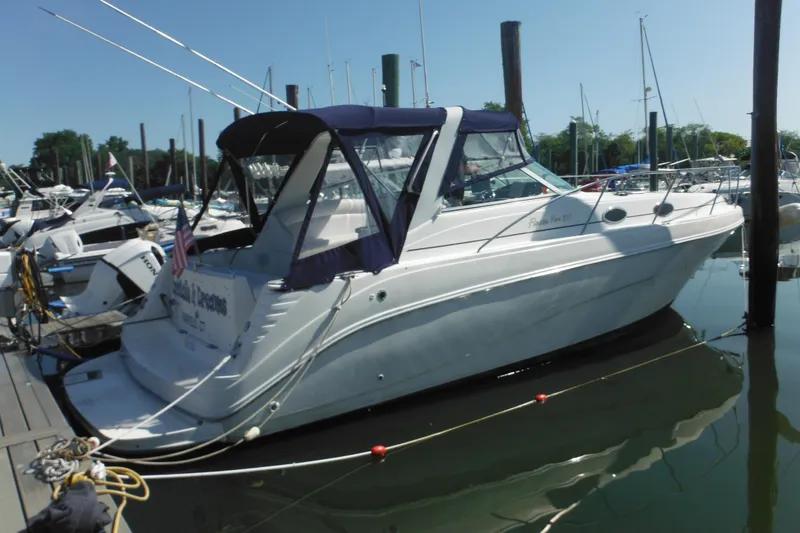 The Image of 2000 Rinker 330 Fiesta Vee boat docked in a marina, side view. - 1