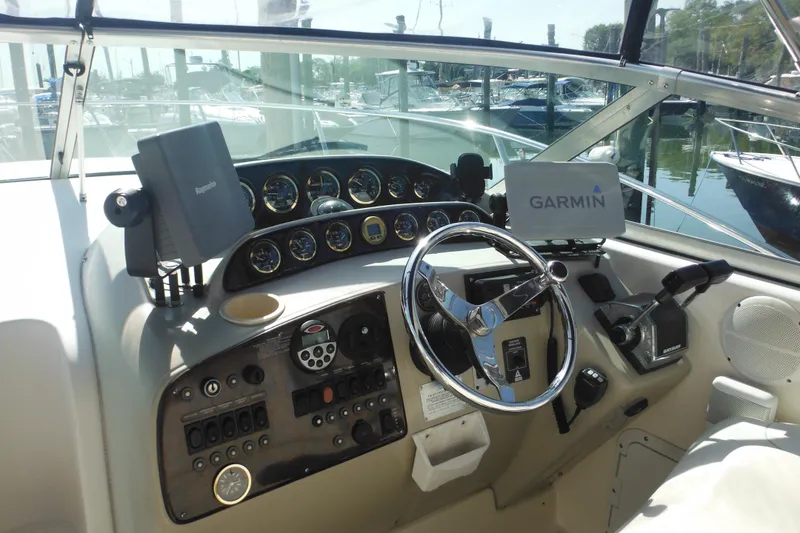 Slide: The Image of Cockpit of 2000 Rinker 330 Fiesta Vee with Garmin navigation system and steering wheel. - 13