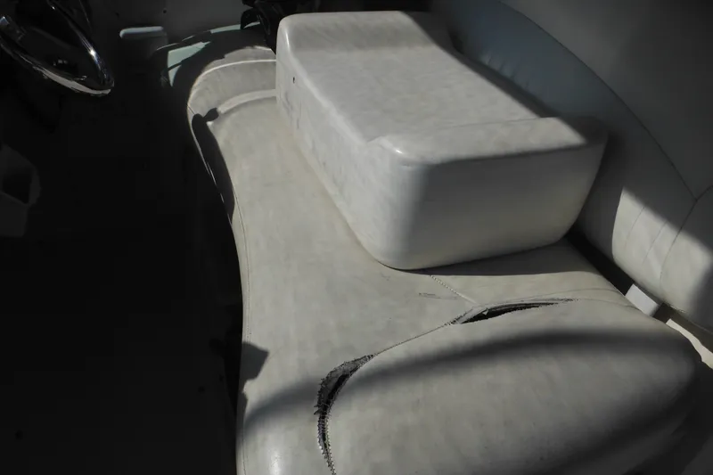 Slide: The Image of Worn seating on 2000 Rinker 330 Fiesta Vee boat, showing visible damage and wear. - 14