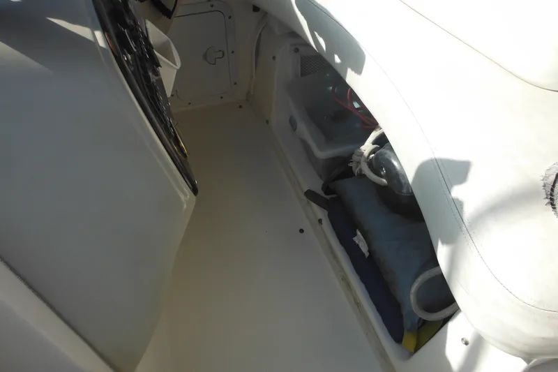 Slide: The Image of Interior view of a 2000 Rinker 330 Fiesta Vee boat, showcasing seating and storage. - 15