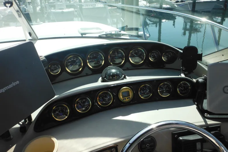 Slide: The Image of Dashboard of a 2000 Rinker 330 Fiesta Vee boat with gauges and navigation equipment. - 22