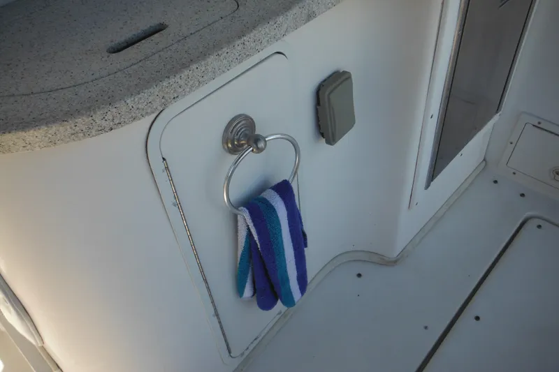 Slide: The Image of Interior of 2000 Rinker 330 Fiesta Vee with towel on ring holder. - 24