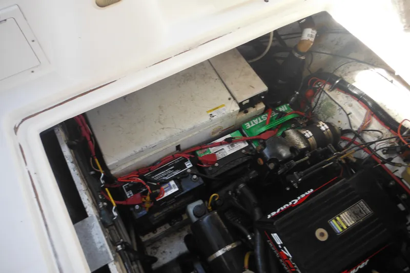 Slide: The Image of Engine compartment of a 2000 Rinker 330 Fiesta Vee boat, showing batteries and wiring. - 36