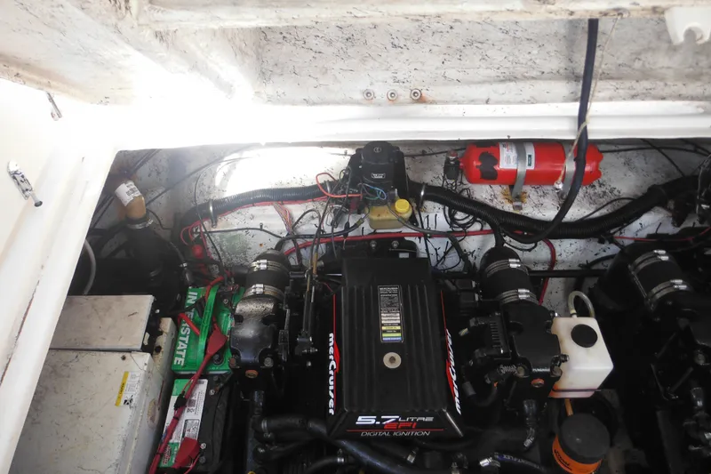 Slide: The Image of Engine compartment of a 2000 Rinker 330 Fiesta Vee boat, featuring MerCruiser components. - 37