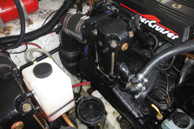 Slide: The Image of Engine compartment of a 2000 Rinker 330 Fiesta Vee boat, featuring MerCruiser components. - 39