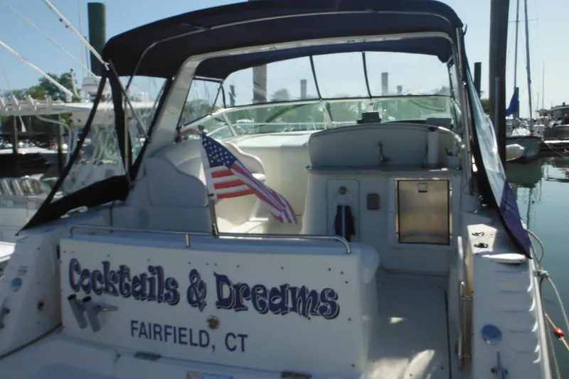 Slide: The Image of 2000 Rinker 330 Fiesta Vee boat with American flag, docked in Fairfield, CT. - 4