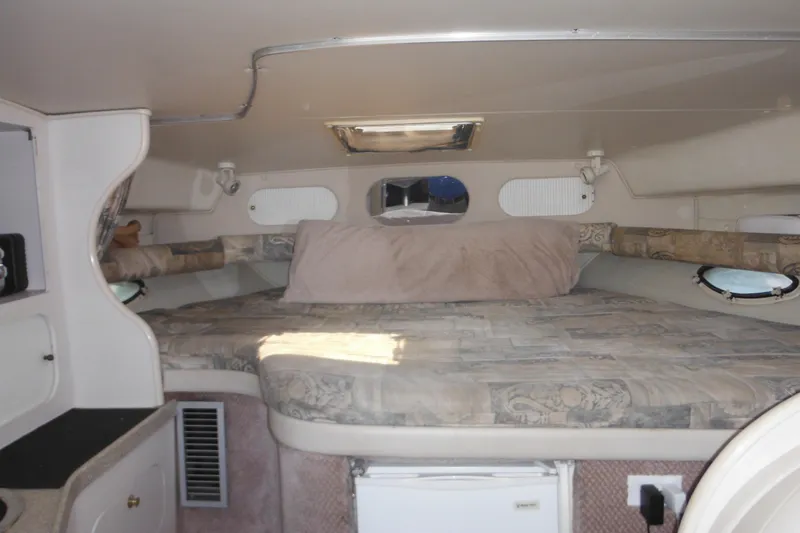 Slide: The Image of Interior cabin of 2000 Rinker 330 Fiesta Vee boat with bed and storage. - 40