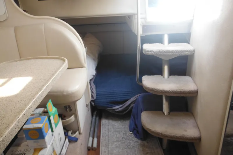 Slide: The Image of Interior of 2000 Rinker 330 Fiesta Vee boat with cozy sleeping area and compact stairs. - 50