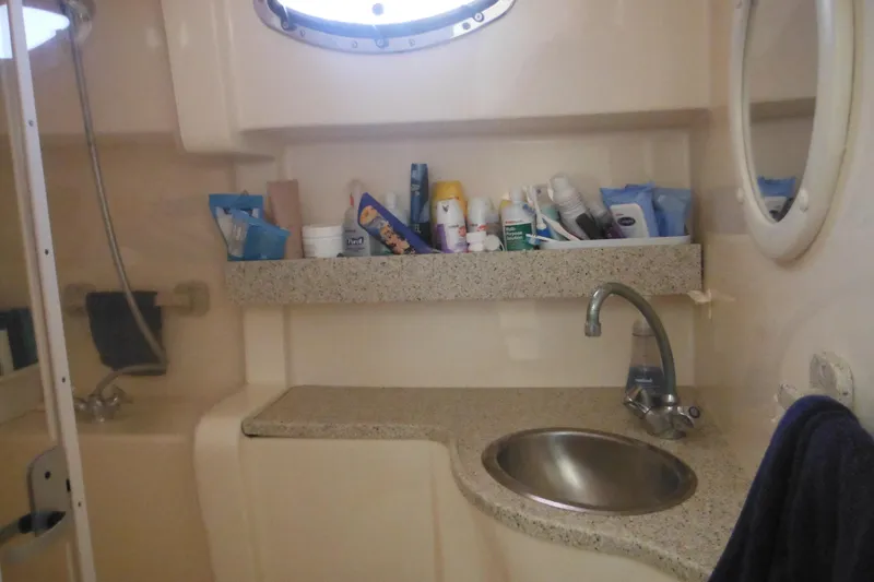 Slide: The Image of Bathroom interior of 2000 Rinker 330 Fiesta Vee boat with sink and toiletries. - 55
