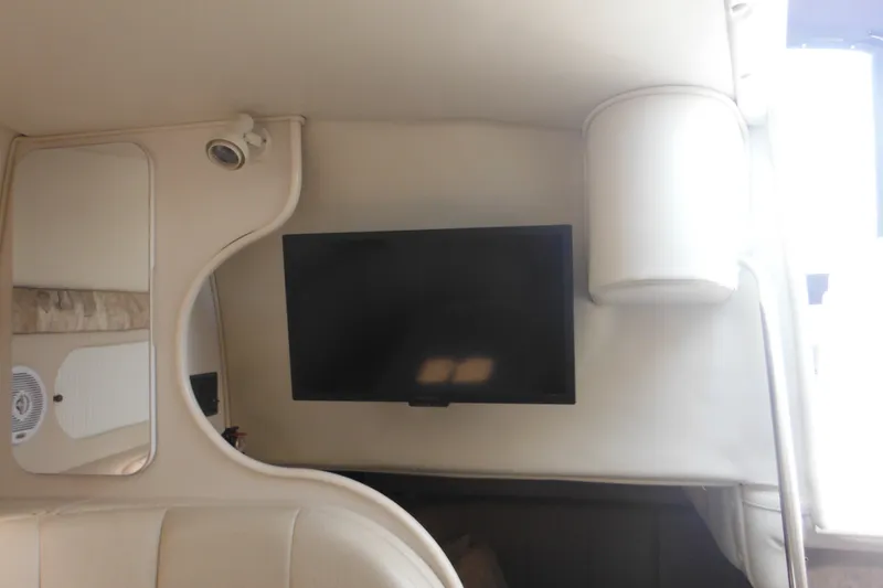 Slide: The Image of Interior of 2000 Rinker 330 Fiesta Vee with mounted TV and mirror. - 59