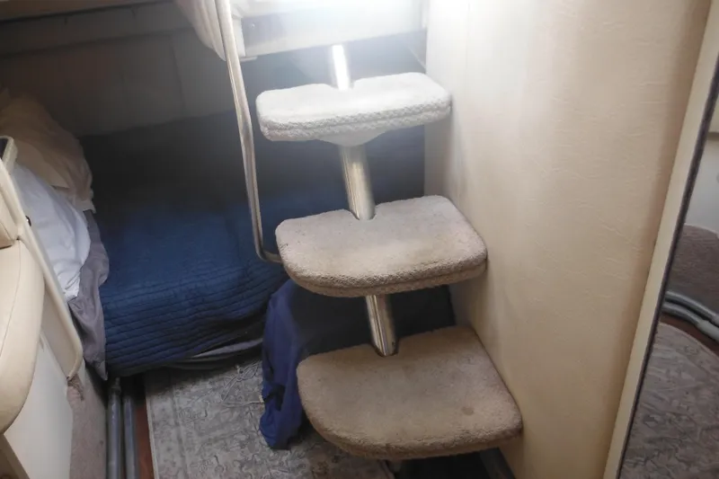 Slide: The Image of Interior of 2000 Rinker 330 Fiesta Vee with carpeted steps and cozy sleeping area. - 63