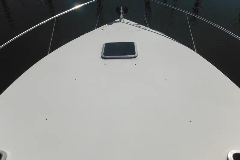 Slide: The Image of Bow view of a 2000 Rinker 330 Fiesta Vee boat on calm water. - 65