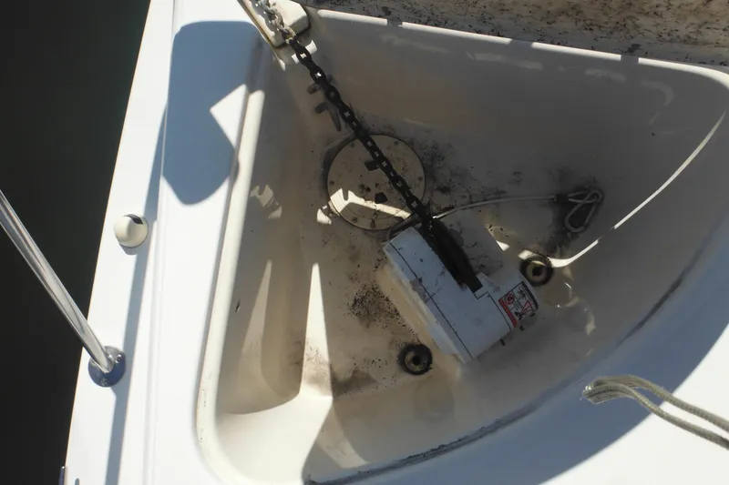 Slide: The Image of Anchor compartment of 2000 Rinker 330 Fiesta Vee boat, showing chain and winch. - 67