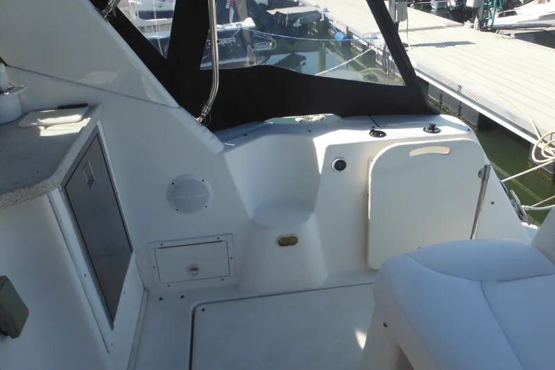Slide: The Image of 2000 Rinker 330 Fiesta Vee boat interior with seating and storage compartments. - 7