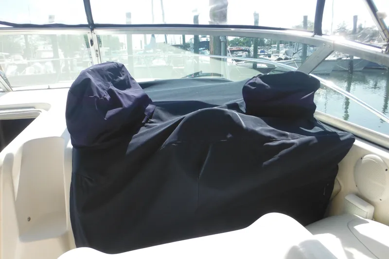 Slide: The Image of 2000 Rinker 330 Fiesta Vee boat interior with covered seating area. - 74