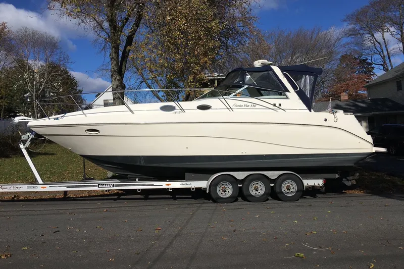 Slide: The Image of 2000 Rinker 330 Fiesta Vee boat on trailer, parked outdoors on a sunny day. - 81