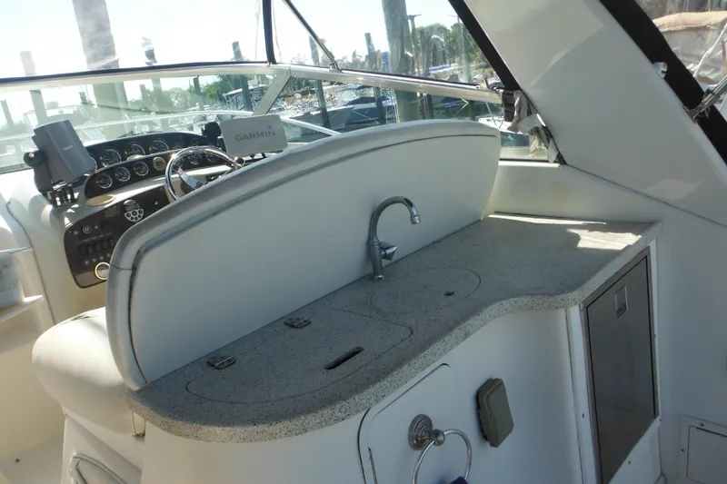 Slide: The Image of 2000 Rinker 330 Fiesta Vee boat interior with helm, Garmin GPS, and kitchenette. - 9