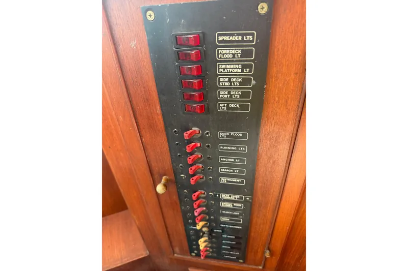 Slide: The Image of Control panel on 1982 Albin 49 Trawler, featuring labeled switches for various boat lights. - 13