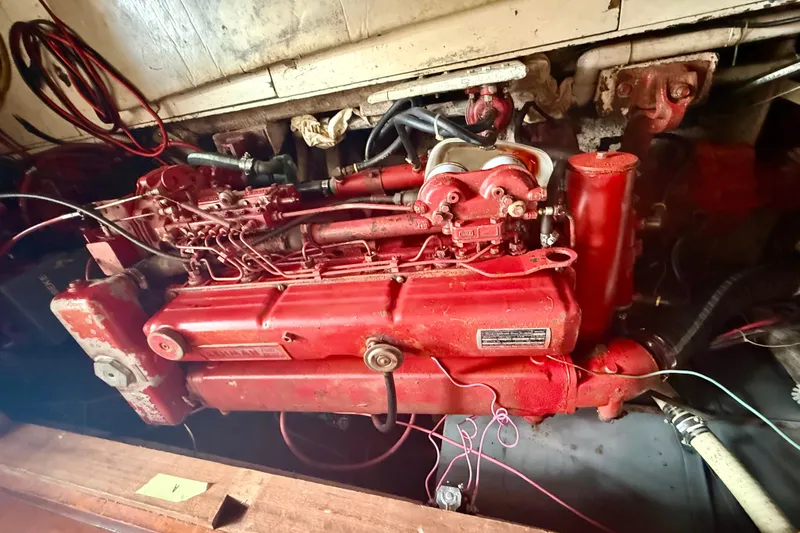 Slide: The Image of Engine of a 1982 Albin 49 Trawler, featuring red components and wiring. - 16
