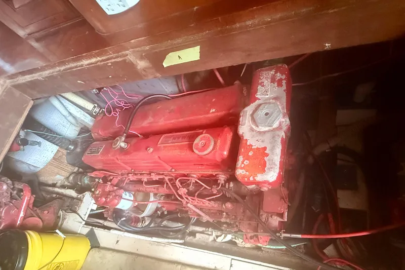 Slide: The Image of Engine compartment of a 1982 Albin 49 Trawler with a red engine. - 17