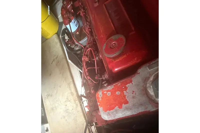 Slide: The Image of Engine compartment of a 1982 Albin 49 Trawler with visible red components. - 18