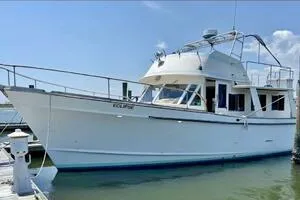 Slide: The Image of 1982 Mainship Trawler docked at marina under clear blue sky. - 2