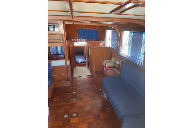 Slide: The Image of Interior of 1982 Albin 49 Trawler with wooden finish and blue seating. - 23