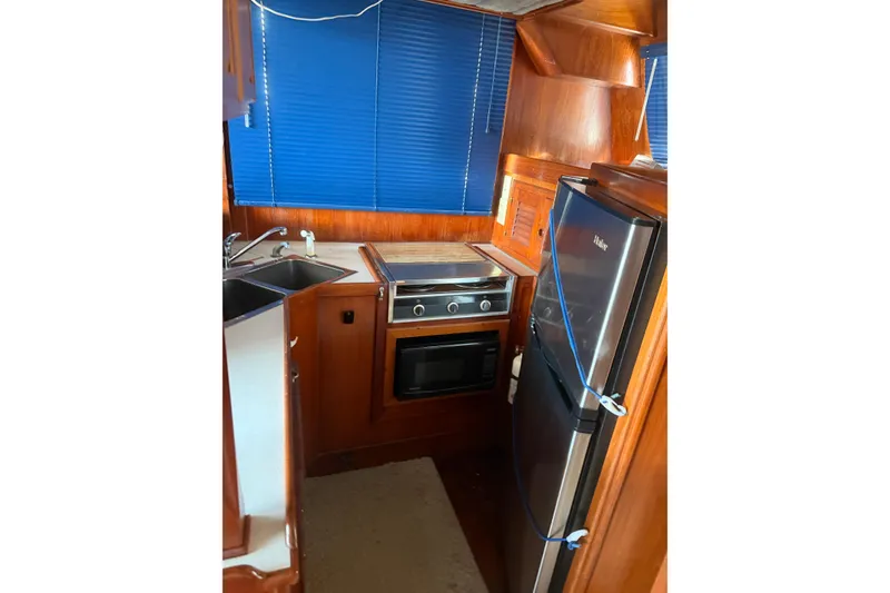 Slide: The Image of Galley kitchen in 1982 Albin 49 Trawler with stove, sink, and refrigerator. - 25