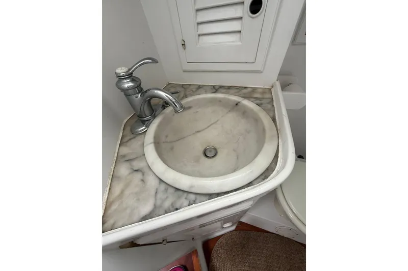 Slide: The Image of Marble sink and faucet in 1982 Albin 49 Trawler bathroom. - 28