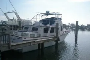 Slide: The Image of 1982 Mainship Trawler docked at a marina, side view. - 3