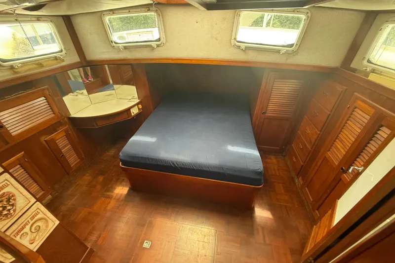 Slide: The Image of Interior of 1982 Albin 49 Trawler with wooden furnishings and a cozy bed. - 31