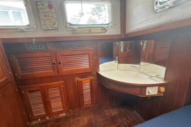 Slide: The Image of Interior of 1982 Albin 49 Trawler with wooden cabinets and mirrored vanity. - 33