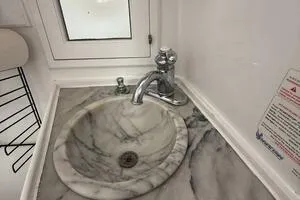 Slide: The Image of Marble sink in 1982 Mainship Trawler boat bathroom with chrome faucet. - 35