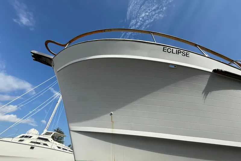 Slide: The Image of 1982 Albin 49 Trawler "Eclipse" under clear blue sky, docked with another boat. - 4