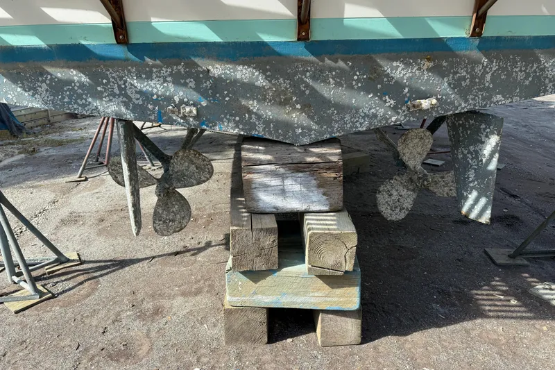 Slide: The Image of 1982 Albin 49 Trawler propellers and hull on wooden blocks, dry docked for maintenance. - 44