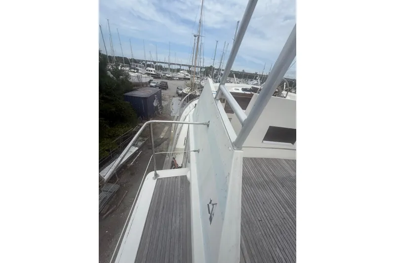 Slide: The Image of 1982 Albin 49 Trawler on deck, marina view with sailboats in background. - 9