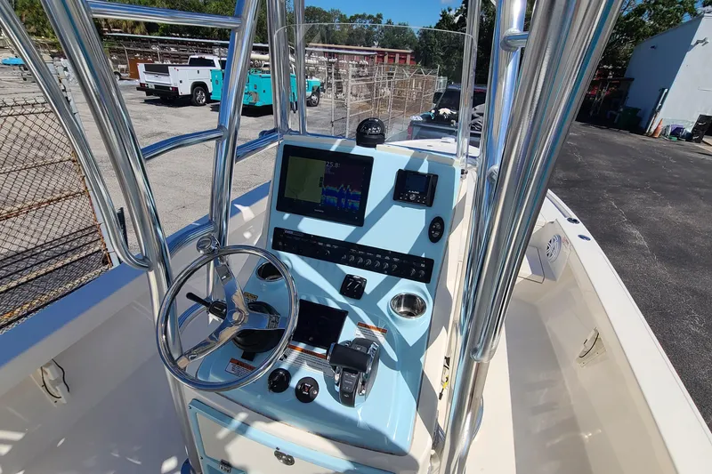 Slide: The Image of 2023 Pathfinder 2500 Hybrid boat console with steering wheel and navigation display. - 18