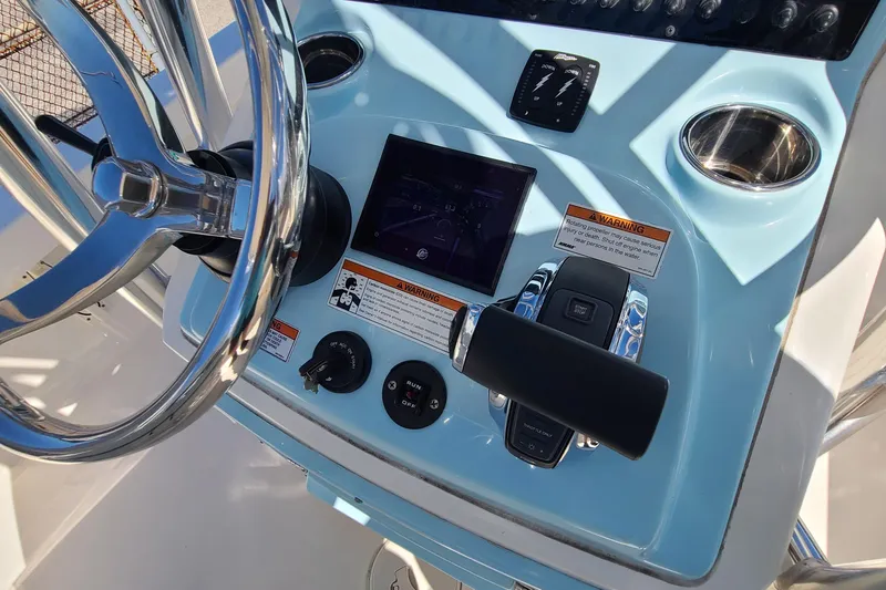 Slide: The Image of 2023 Pathfinder 2500 Hybrid boat dashboard with steering wheel and control panel. - 19