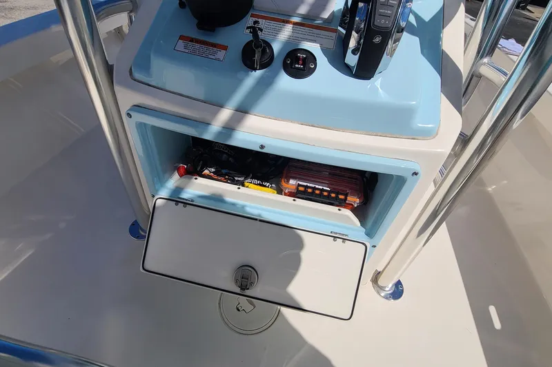 Slide: The Image of 2023 Pathfinder 2500 Hybrid boat console with open storage compartment. - 20