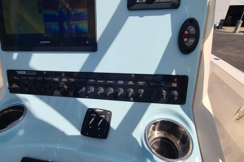 Slide: The Image of Control panel of 2023 Pathfinder 2500 Hybrid boat with Garmin display and switches. - 22