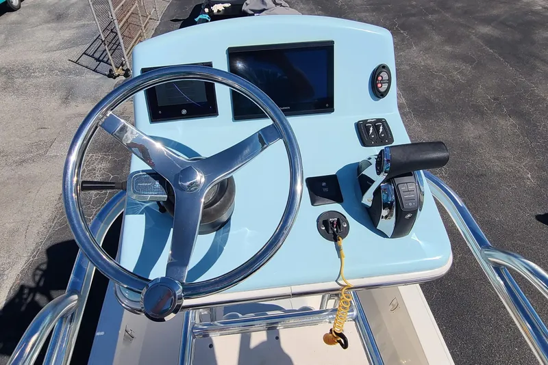 Slide: The Image of 2023 Pathfinder 2500 Hybrid boat console with steering wheel and controls. - 24