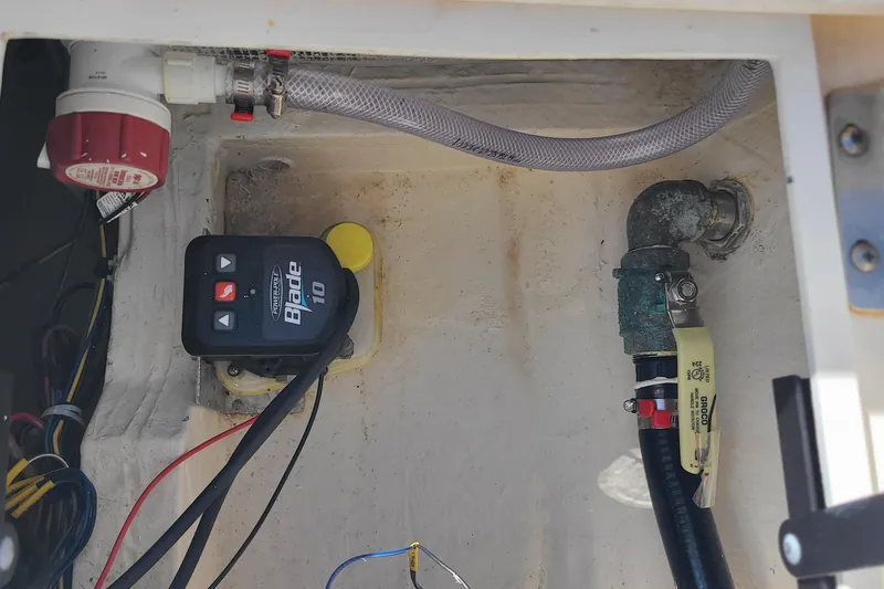 Slide: The Image of 2023 Pathfinder 2500 Hybrid boat wiring and plumbing components in compartment. - 38