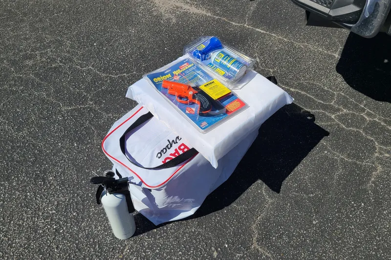Slide: The Image of Bag and emergency supplies on asphalt near a 2023 Pathfinder 2500 Hybrid. - 39
