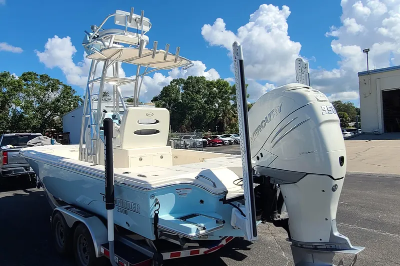 Slide: The Image of 2023 Pathfinder 2500 Hybrid boat with Mercury engine on trailer, under blue sky. - 4
