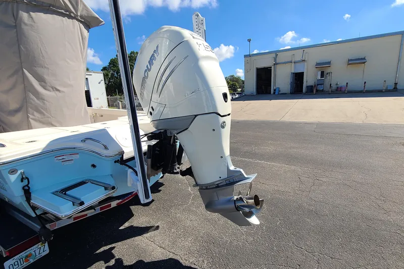 Slide: The Image of 2023 Pathfinder 2500 Hybrid boat with Mercury outboard motor in a parking lot. - 5