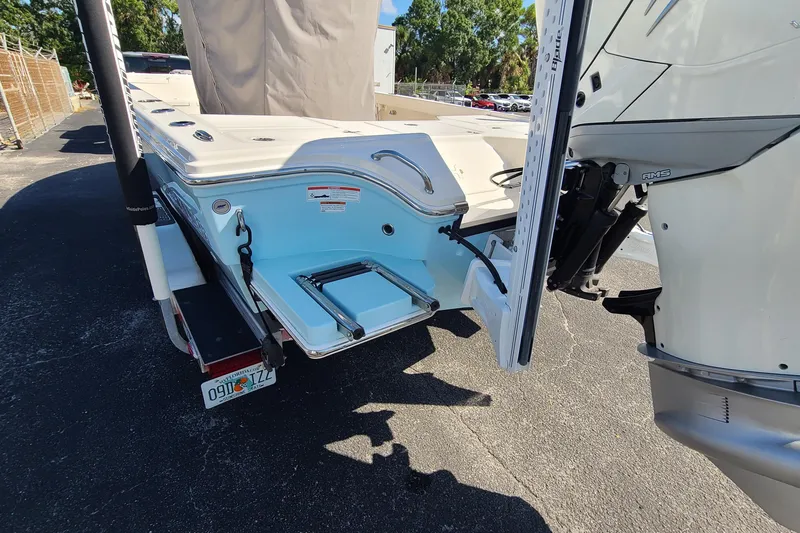Slide: The Image of 2023 Pathfinder 2500 Hybrid boat rear view with motor and swim platform. - 7