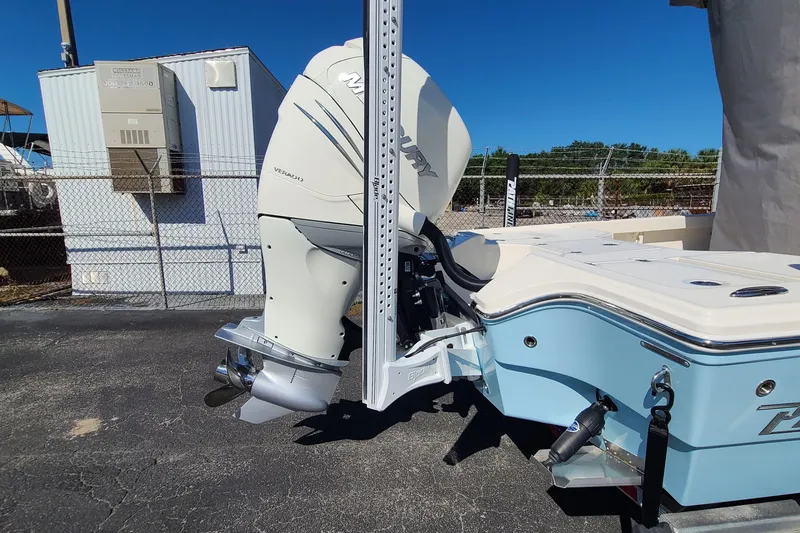 Slide: The Image of 2023 Pathfinder 2500 Hybrid boat with Mercury outboard motor, parked outdoors. - 9