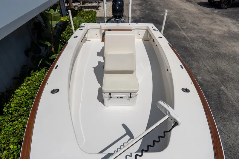 Slide: The Image of 2022 Croswait Custom Carolina 21 boat with white seating and trolling motor. - 17