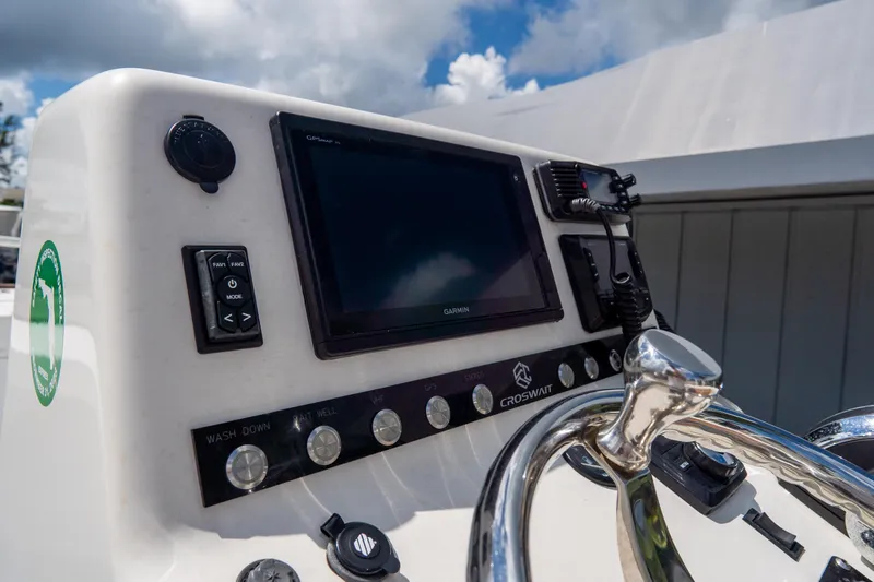 Slide: The Image of Croswait Custom Carolina 21 boat dashboard with Garmin display and controls, 2022 model. - 21