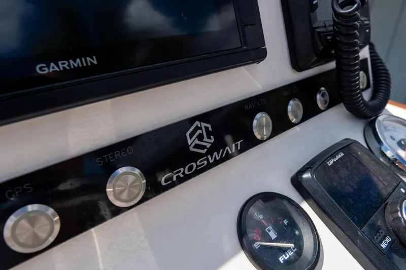 Slide: The Image of Croswait Custom Carolina 21 boat dashboard with Garmin GPS and control buttons, 2022 model. - 22